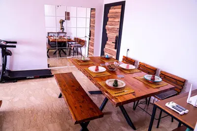 a dining room with a wooden table and chairs at Beautiful and Stylish 2BR Appartment with a wide Beach View in Mohammedia