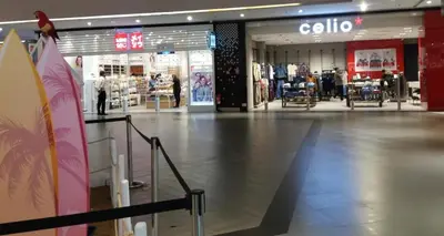 an empty shopping mall with a lot of stores at Magnifique Studio Gare - Tram in Les Camps
