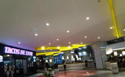 a shopping mall with a sign that reads tacos be ban at Magnifique Studio Gare - Tram in Les Camps