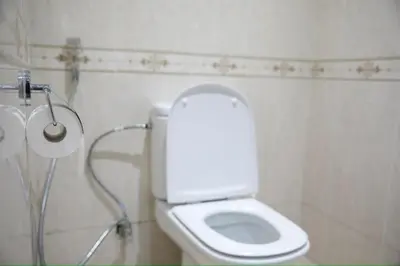 a white toilet in a bathroom with a shower at Appartement moderne en plein centre de l'Agdal in Rabat