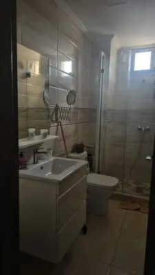 a bathroom with a sink and a toilet and a shower at Appartement proche de la mer de bouznika in Bouznika