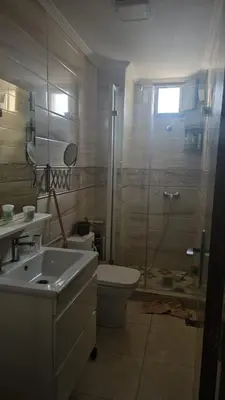 a bathroom with a shower and a toilet and a sink at Appartement proche de la mer de bouznika in Bouznika