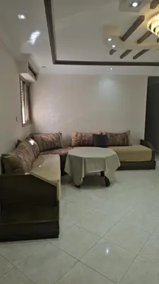 a living room with a couch and a table at Appartement proche de la mer de bouznika in Bouznika