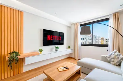 a living room with a couch and a tv at Modern and Luxurious apartment in Rabat