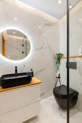 a bathroom with a black sink and a mirror at Modern and Luxurious apartment in Rabat