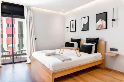 a white bedroom with a bed with a table on it at Modern Elegance in City Core in Gare de Rabat-Aguedal
