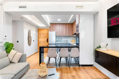 a living room with a couch and a kitchen at Modern Elegance in City Core in Gare de Rabat-Aguedal
