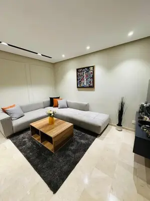a living room with a couch and a coffee table at Studio Al Amir 12 CFC à 2mn in Casablanca
