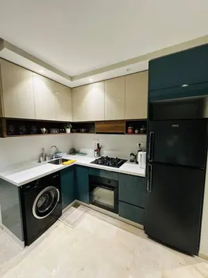a kitchen with a black refrigerator and a dishwasher at Studio Al Amir 12 CFC à 2mn in Casablanca
