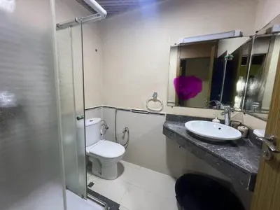a bathroom with a toilet and a sink and a mirror at Les perles de tamaris in Dar Mohammed Ould Haj Jilali
