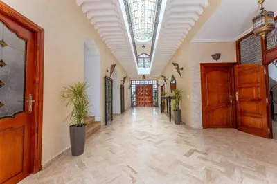 a hallway with potted plants and a ceiling at Bienvenue au Château Loriana ! in Bouznika