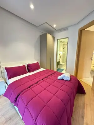 a bedroom with a large purple bed in a room at Little paradis Casablanca in Casablanca