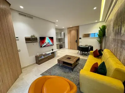 a living room with a yellow couch and a table at Little paradis Casablanca in Casablanca