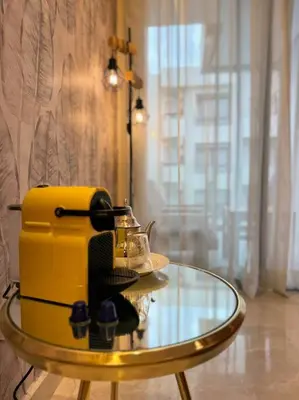 a glass table with a yellow appliance on top of it at Little paradis Casablanca in Casablanca