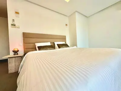 a bedroom with a large white bed with two pillows at Appartement Luxueux Spacieux & une Vue Panoramique in Casablanca
