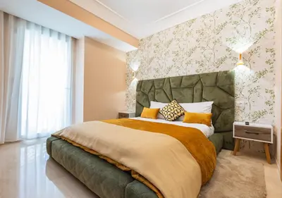 a bedroom with a large bed with a large headboard at Les Tours Végétales, Casablanca Finance City in Casablanca