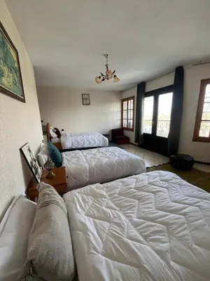 a large bedroom with two beds and a couch at surf trip in Kasba Bou Hamira