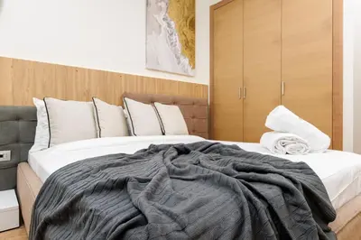 a bedroom with a large bed with a blanket on it at Elegant 2BR in Hay Riad - New Furnishings & Design in Beni Brour