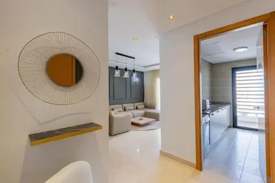 a living room with a mirror on the wall at Luxurious and modern 2BR with Stunning View in Beni Brour