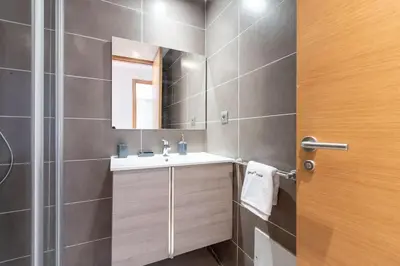 a bathroom with a sink and a mirror at Luxurious and modern 2BR with Stunning View in Beni Brour