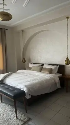 a bedroom with a large bed with white sheets and pillows at Modern meets traditional ! in Casablanca