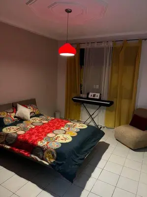 a bedroom with a bed and a table and a chair at Modern meets traditional ! in Casablanca