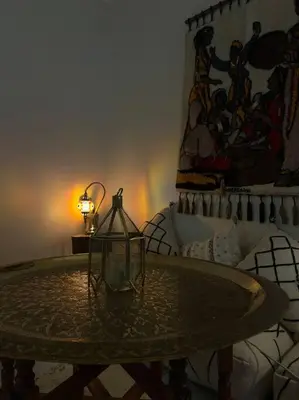 a table with a lamp in a room with a bed at Modern meets traditional ! in Casablanca