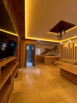 a living room with a television and a couch at Casa Jnane Jawhara Skhirat in Rabat