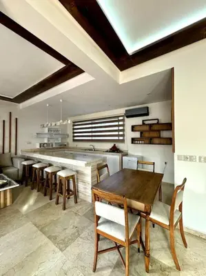 a kitchen with a table and chairs and a counter at Jnane Jawhara Skhirat house in Skhirat