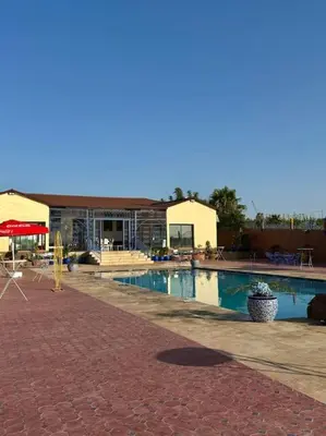 a swimming pool in front of a building at Jnane Jawhara Skhirat house in Skhirat