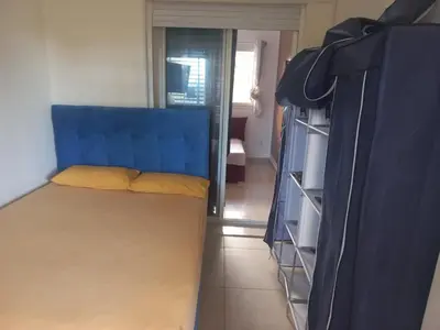 a bed with a blue headboard in a room at vague bleue de bouznika in Bouznika