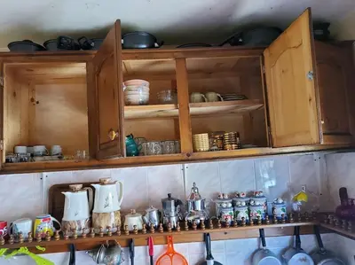 a shelf filled with lots of pots and pans at à 10 minutes du grand mall d'Afrique, WiFi Netflix 1ère étage in Oulad Hamida