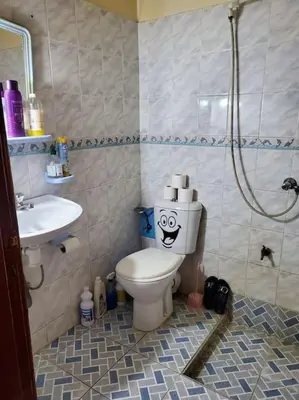 a bathroom with a toilet with a face drawn on it at à 10 minutes du grand mall d'Afrique, WiFi Netflix 1ère étage in Oulad Hamida