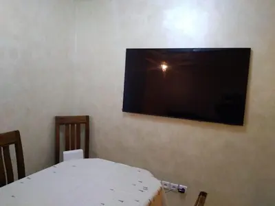 a flat screen tv hanging on a wall at Appartement in Casablanca