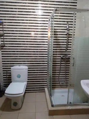 a bathroom with a shower and a toilet and a sink at Appartement in Casablanca