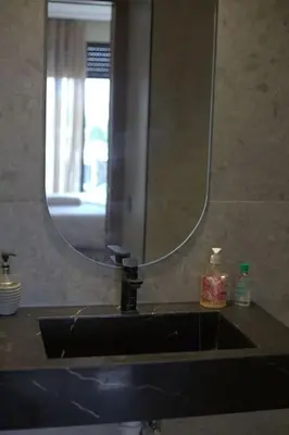 a bathroom sink with a large mirror above it at Studio cosy à Maârif, Palmiers in Maarif