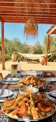a table with plates of food on top of it at Kasbah Oum Rabia in Boulaouane
