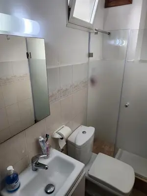 a bathroom with a toilet and a sink and a mirror at Appartement confortable et bien situé in Casablanca