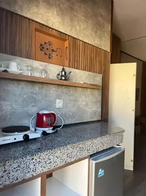 a kitchen with a red tea kettle on a counter at Jnane Jawhara Skhirat studio in Skhirat