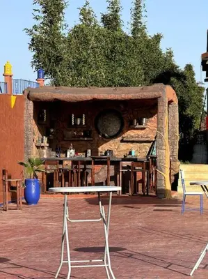 a table and chairs in front of a building at Jnane Jawhara Skhirat studio in Skhirat