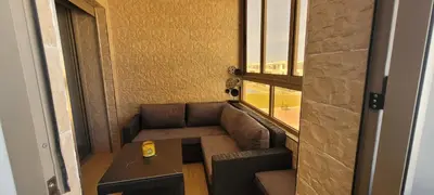 a room with a couch and a table and a window at Appart à Malaga Beach Mansouria in Mansouria