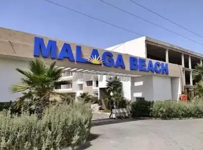 a mobilosa beach building with a sign on it at Appart à Malaga Beach Mansouria in Mansouria
