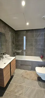 a bathroom with a tub and a sink and a toilet at le carrousel Rabat Océan in Kouas