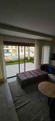 a bedroom with a bed and a large window at le carrousel Rabat Océan in Kouas