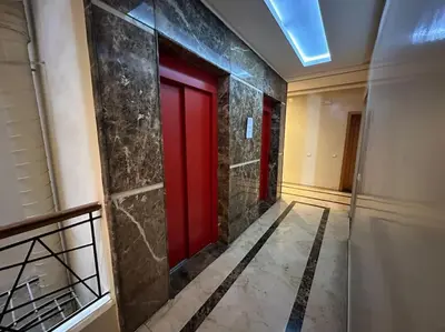 a hallway with red doors in a building at Cosy and practical apartment in Maarif