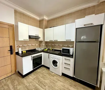 a kitchen with a stainless steel refrigerator and a dishwasher at Cosy and practical apartment in Maarif