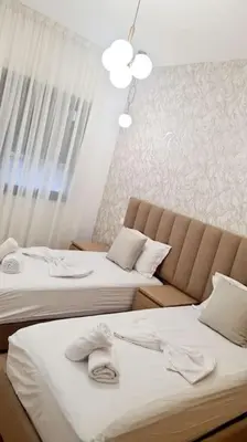 two beds in a hotel room with towels on them at Chic & Charme Studio Près de l'aéroport in Nouaceur