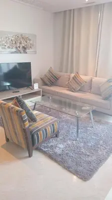 a living room with a couch and a coffee table at studio by rent inn in Rabat