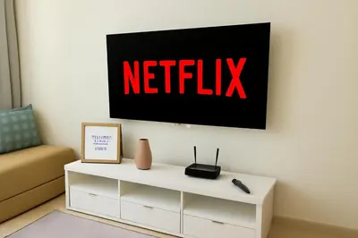 a tv hanging on a wall above a white cabinet at studio by rent inn in Rabat