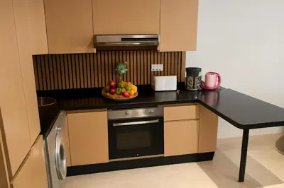 a kitchen with a bowl of fruit on a counter at studio by rent inn in Rabat